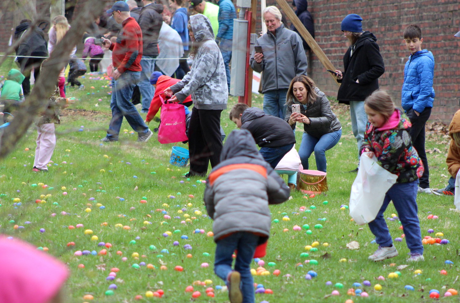 Dozens of egg seekers in the 5-and-under category sprint to grab as many Easter eggs as possible Saturday.